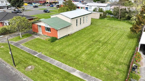 Image shows aerial view of a hall sitting on a section covered by grass