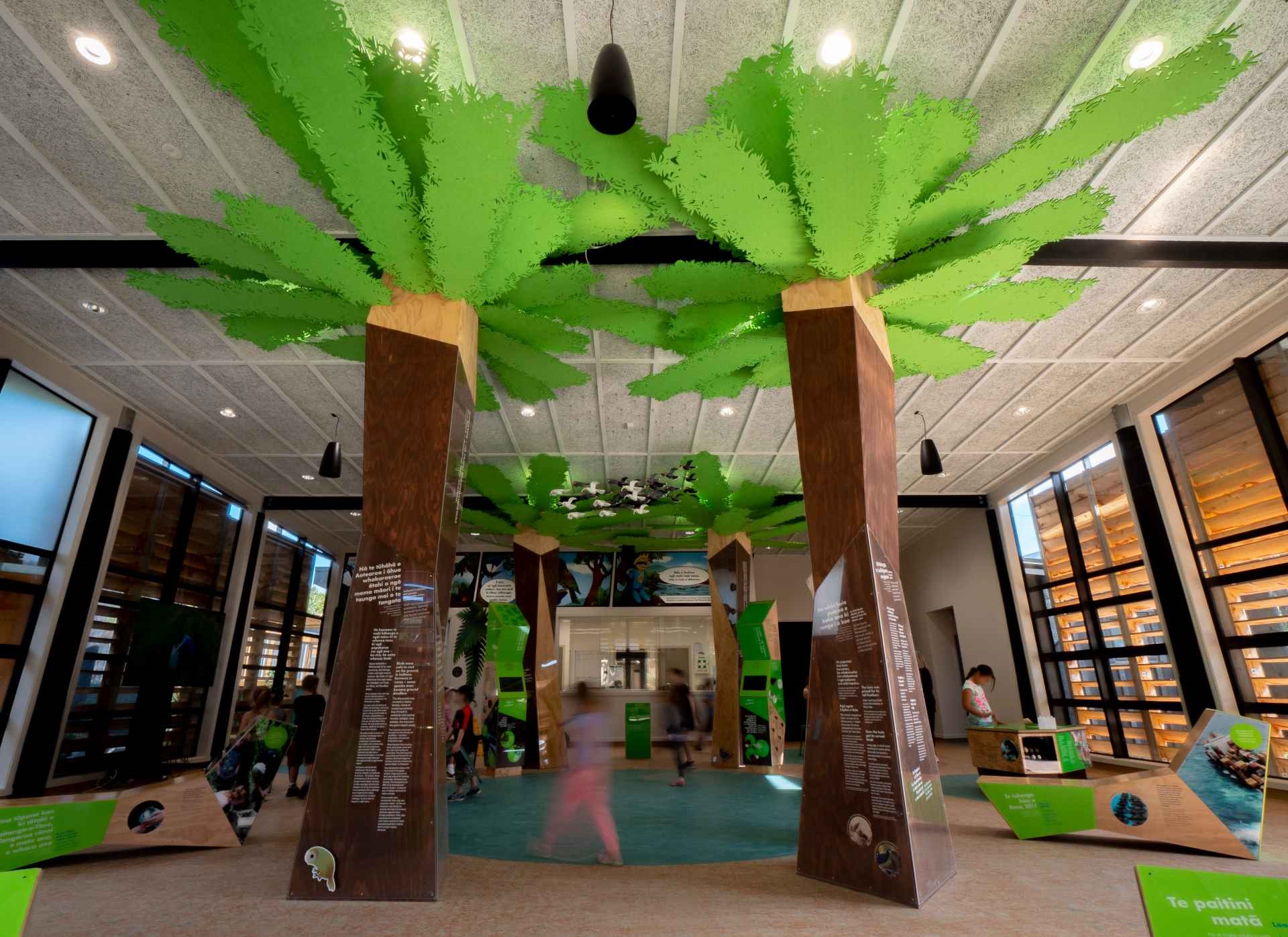 Children inside the education centre, which is fitted out with playful sculptures of trees and birds.