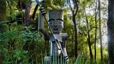 Giant carving of Rangitāne ancestor Whatonga in the forest.