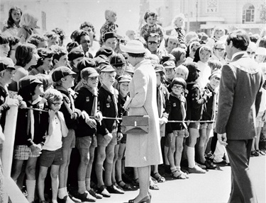 Queen Elizabeth II chats with a group of boy scouts, 26 February 1977.