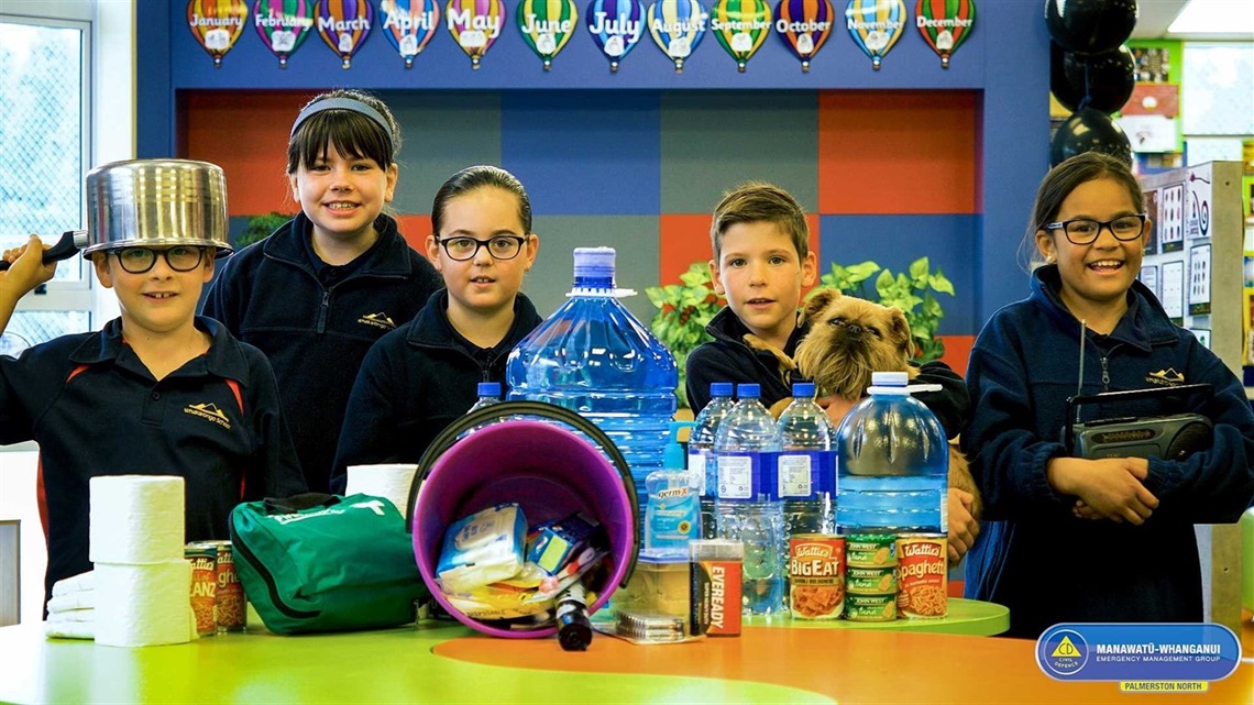 Five primary school kids and dog prepare an emergency survival kit that includes loo paper, water and tinned food.