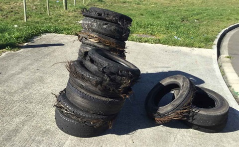 Photo shows tyres that have been dumped on the footpath.