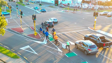 Image shows some bicycles waiting at a crossing.