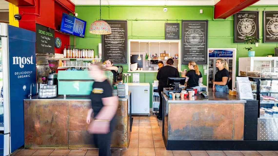 Staff working behind the counter at a busy Palmy café