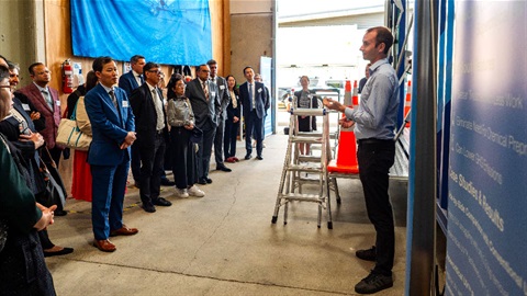 image shows a man briefing a group of visitors