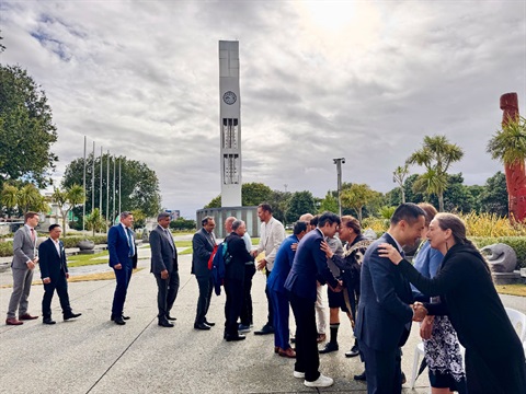 image shows people being greeted on a square