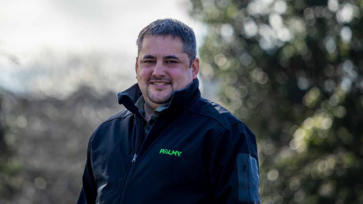 Nathan, Environmental Health Coordinator, wearing a Palmy jacket outdoors.