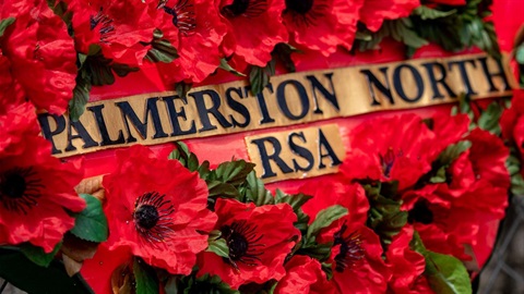 A wreath of red poppies bearing the legend, 