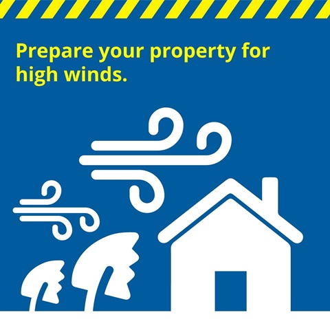 Illustration shows trees bending towards a house in high winds.