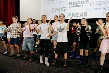 Children on stage performing the Gumboot Song.
