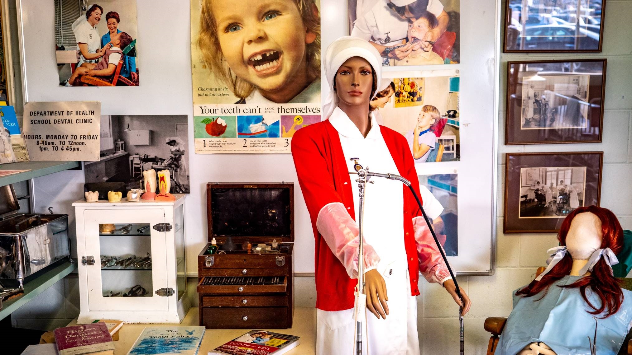 School dental clinic, complete with retro dental care posters, photographs and vintage instruments, and mannequins of a child undergoing treatment from the school dental nurse.