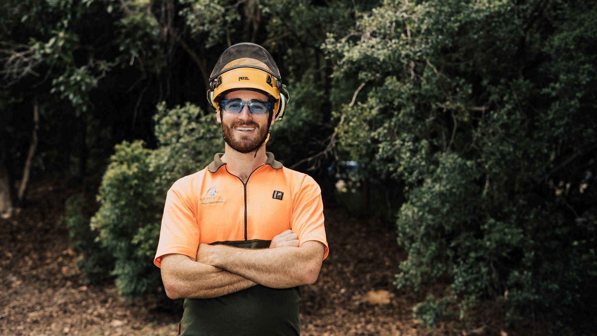 Arborist Jack Taylor standing among trees.