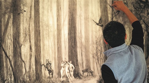 The artist rendering a forest scene in charcoal.