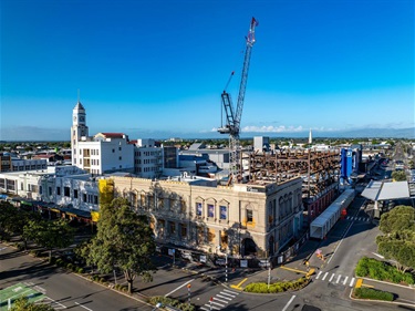 image shows a construction site with a massive crane