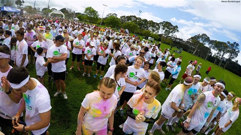 Large group of people gathered in a park about to start a run.