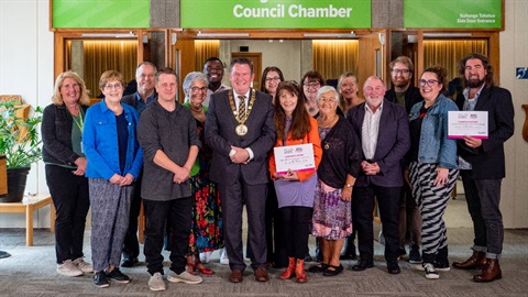 Group photo of grant recipients and politicians. 