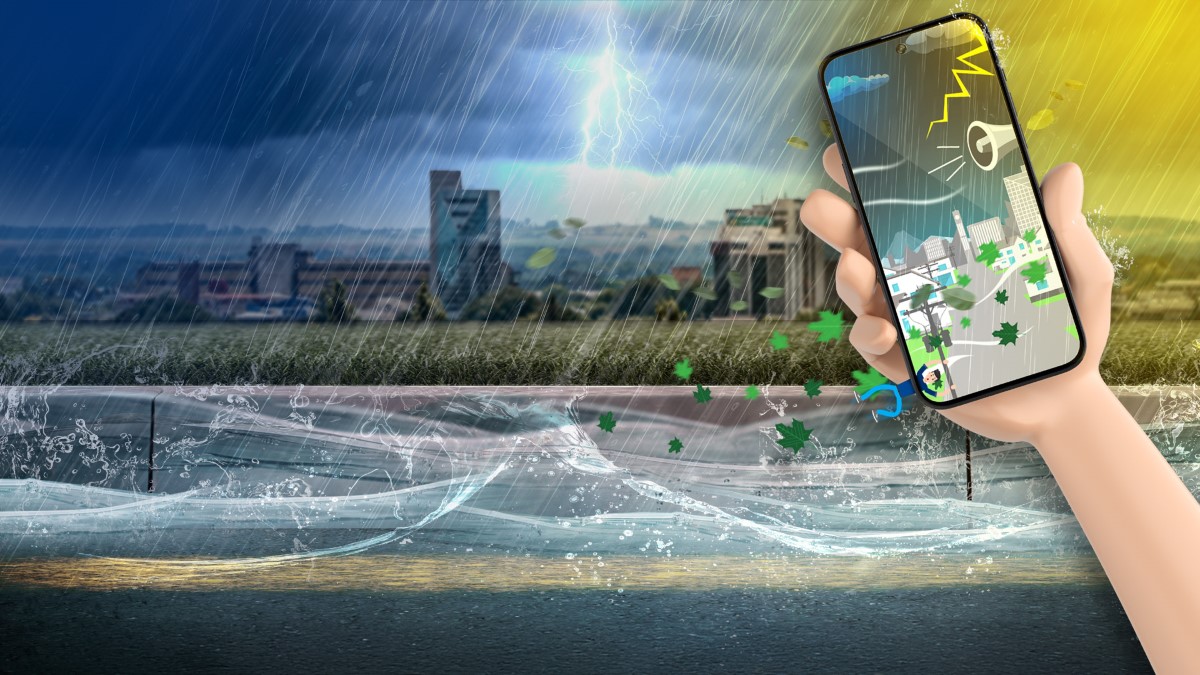 Palmerston North cityscape in a storm, overlaid with a mobile phone sounding an emergency alert.