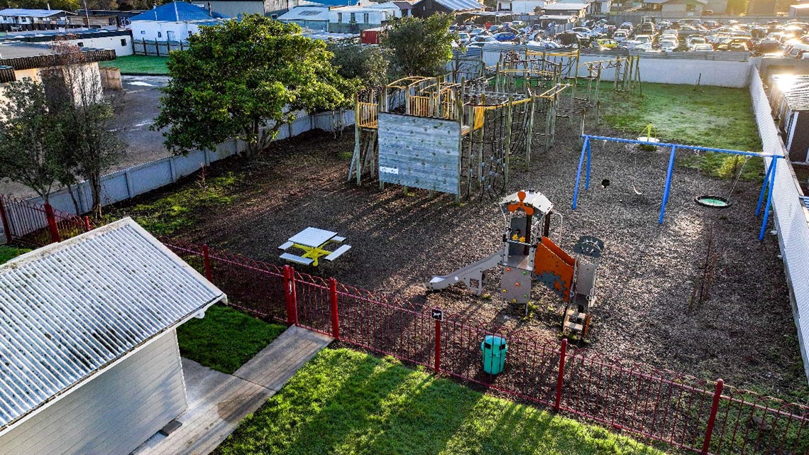 Image shows aerial view of a playground with fence