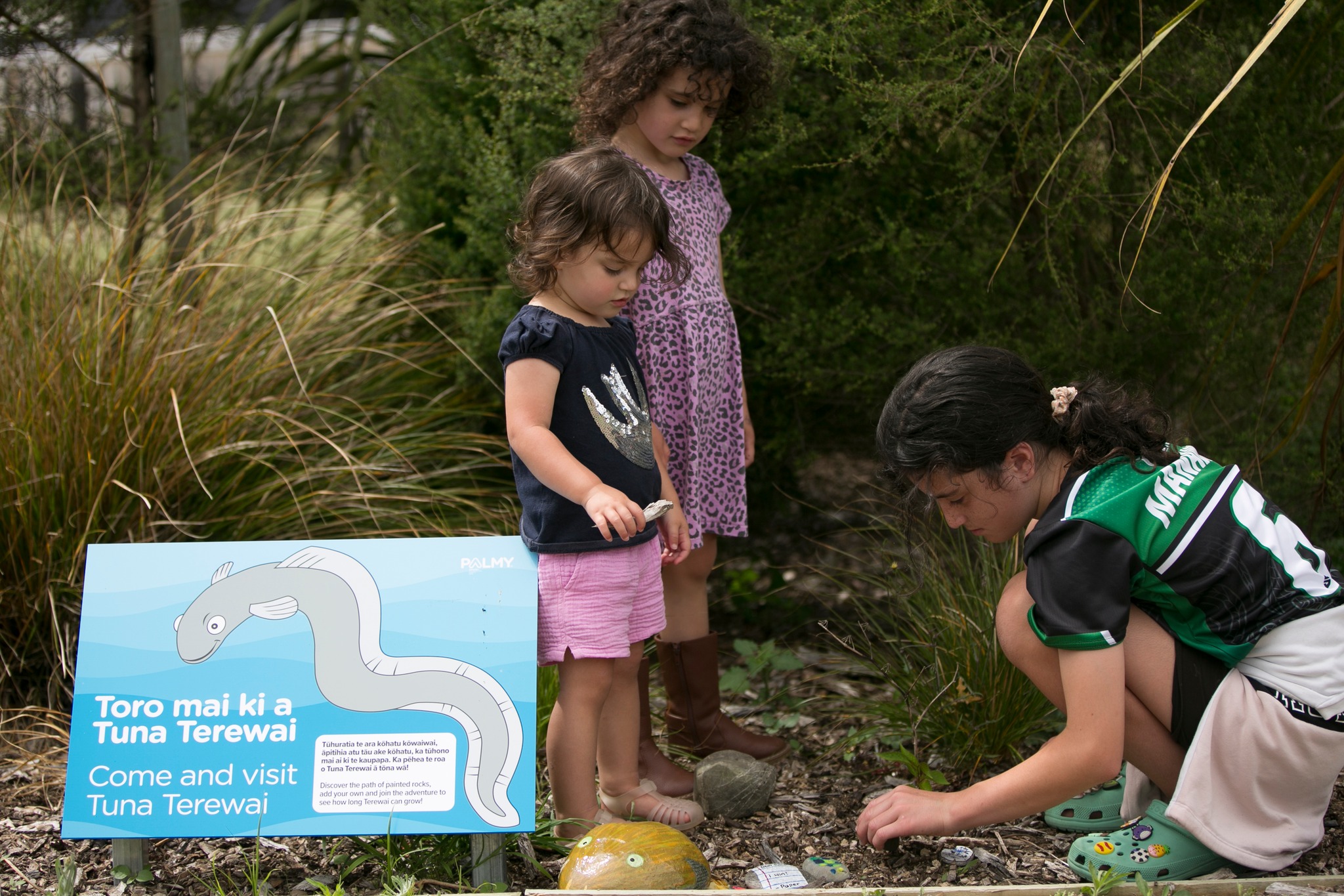 kids putting a painted rock tuna together