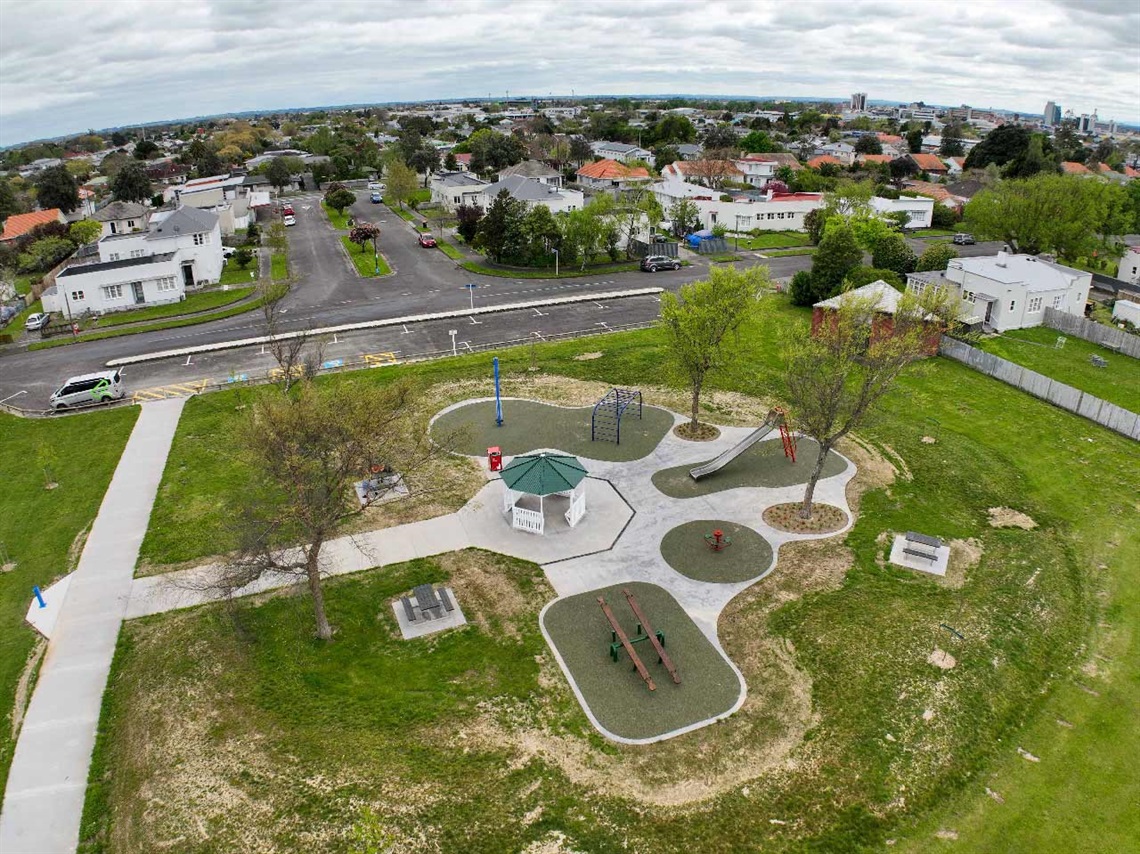Photo shows aerial view of a playground with the city in background.