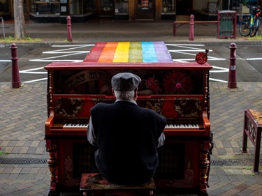 Someone plays a piano on George Street.