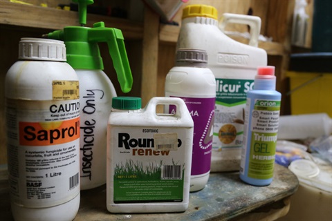 Image shows containers of chemical products on a table