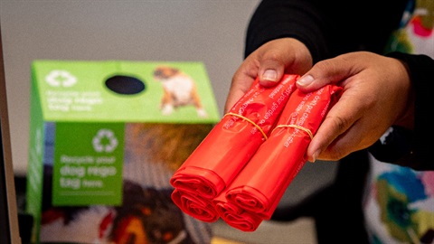 Image shows two wrapped rubbish bags being presented. 