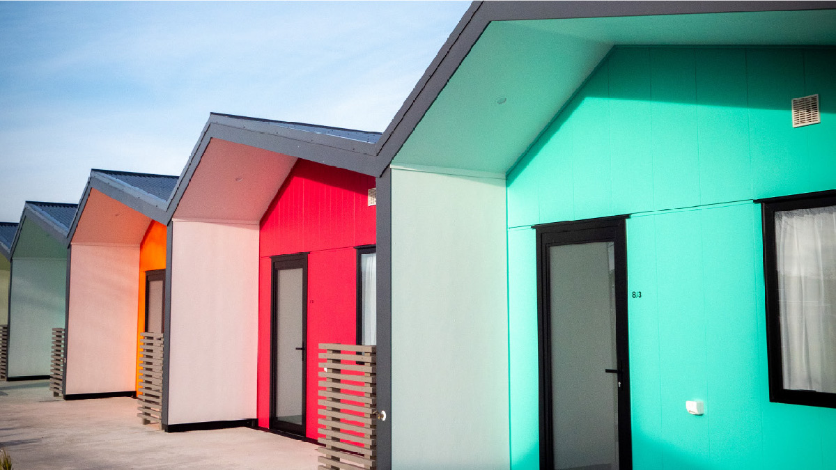 Image shows newly built terrace houses in multiple colours