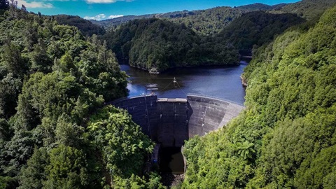 Aerial shot of the dam surrounded by native bush.