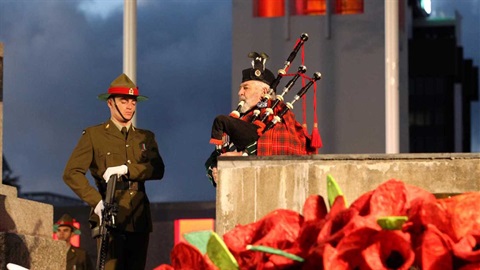 Soldier and piper at Anzac Day dawn service at Palmerston North cenotaph.