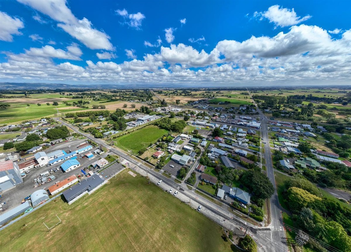 Aerial view of Bunnythorpe village under a blue sky.