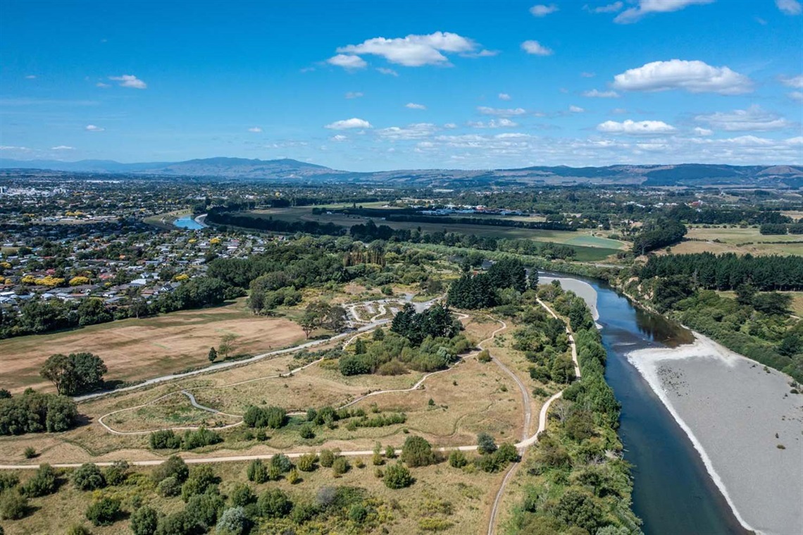 Image shows ariel view of a walkway by the river.