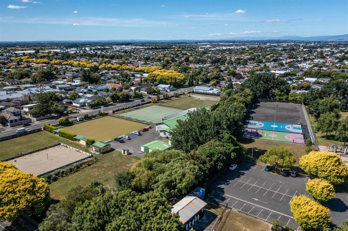 Image shows ariel view of netball courts and sportfield.