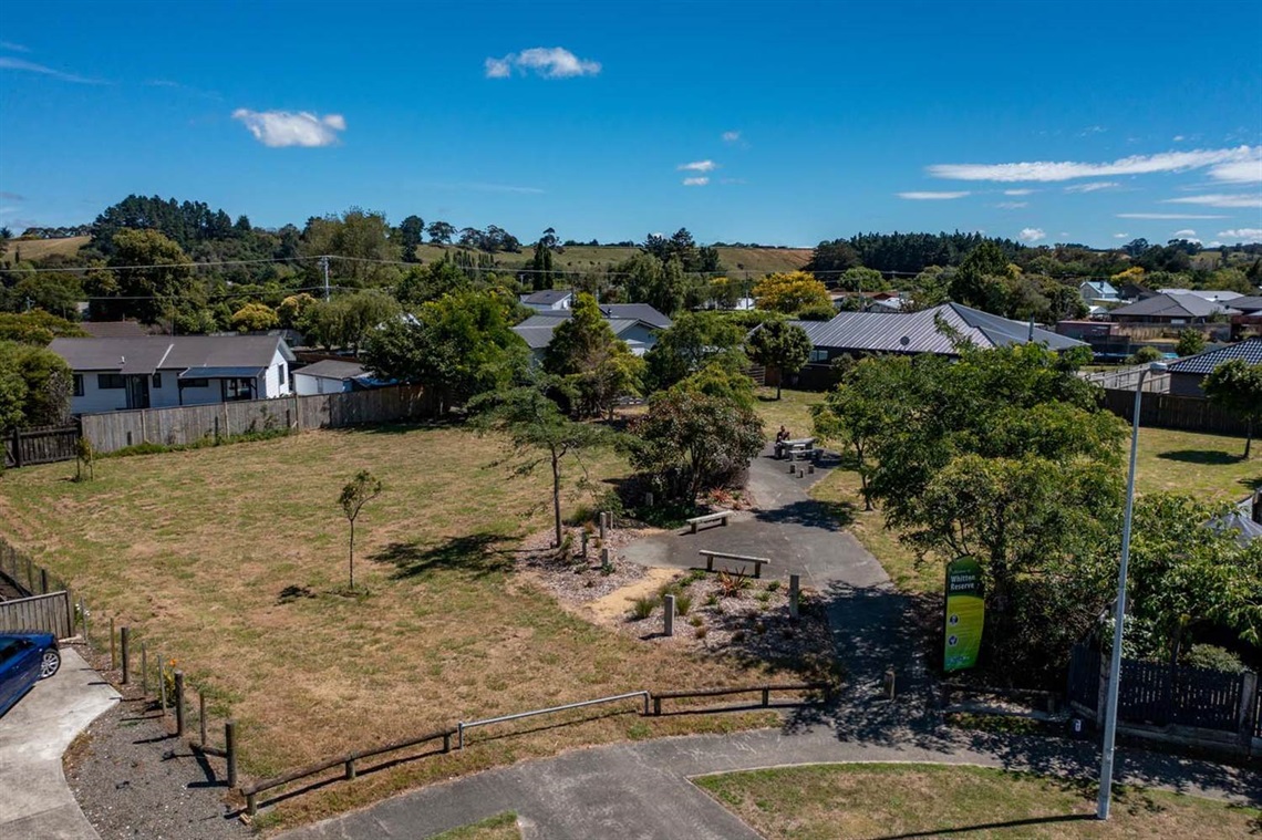 Image shows ariel view of chairs and a picnic table in a park