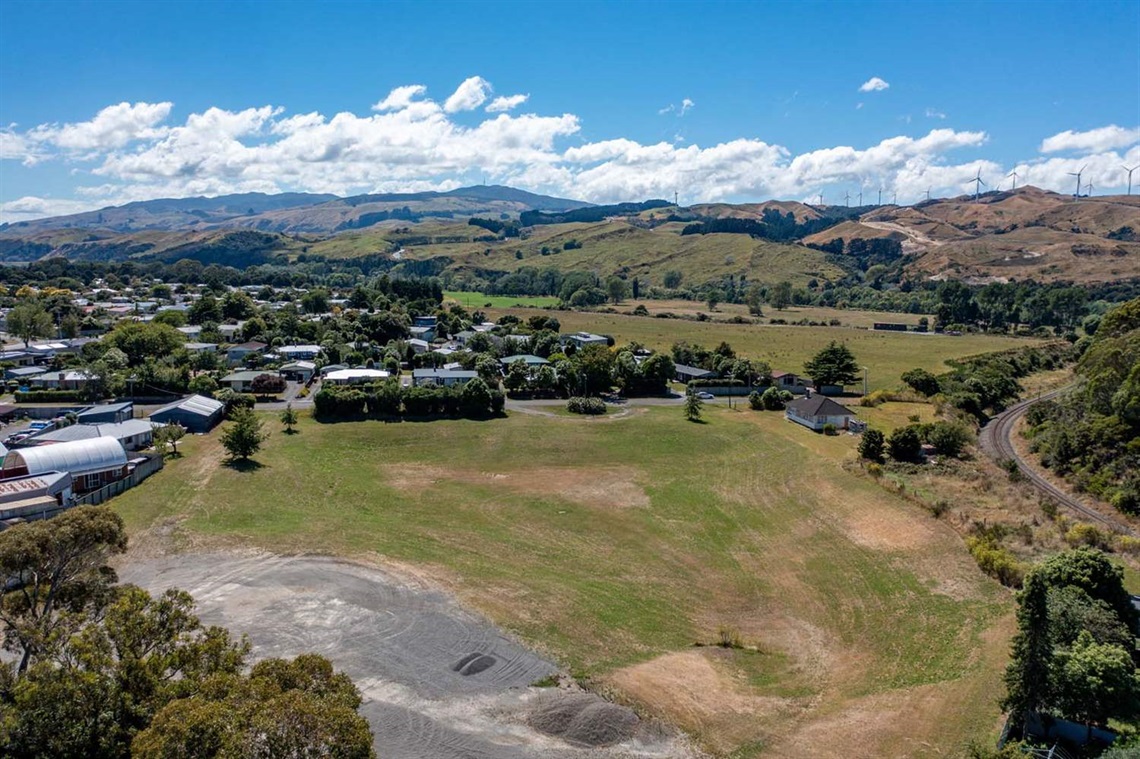 Image shows ariel view of grass field in a park.