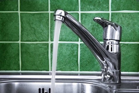 Tap with water running into a sink.