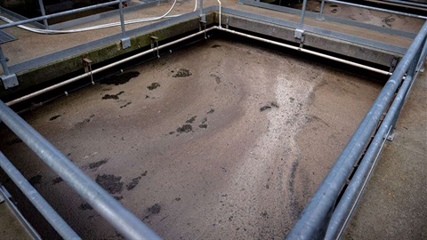 Photo shows tank filled with wastewater slurry.
