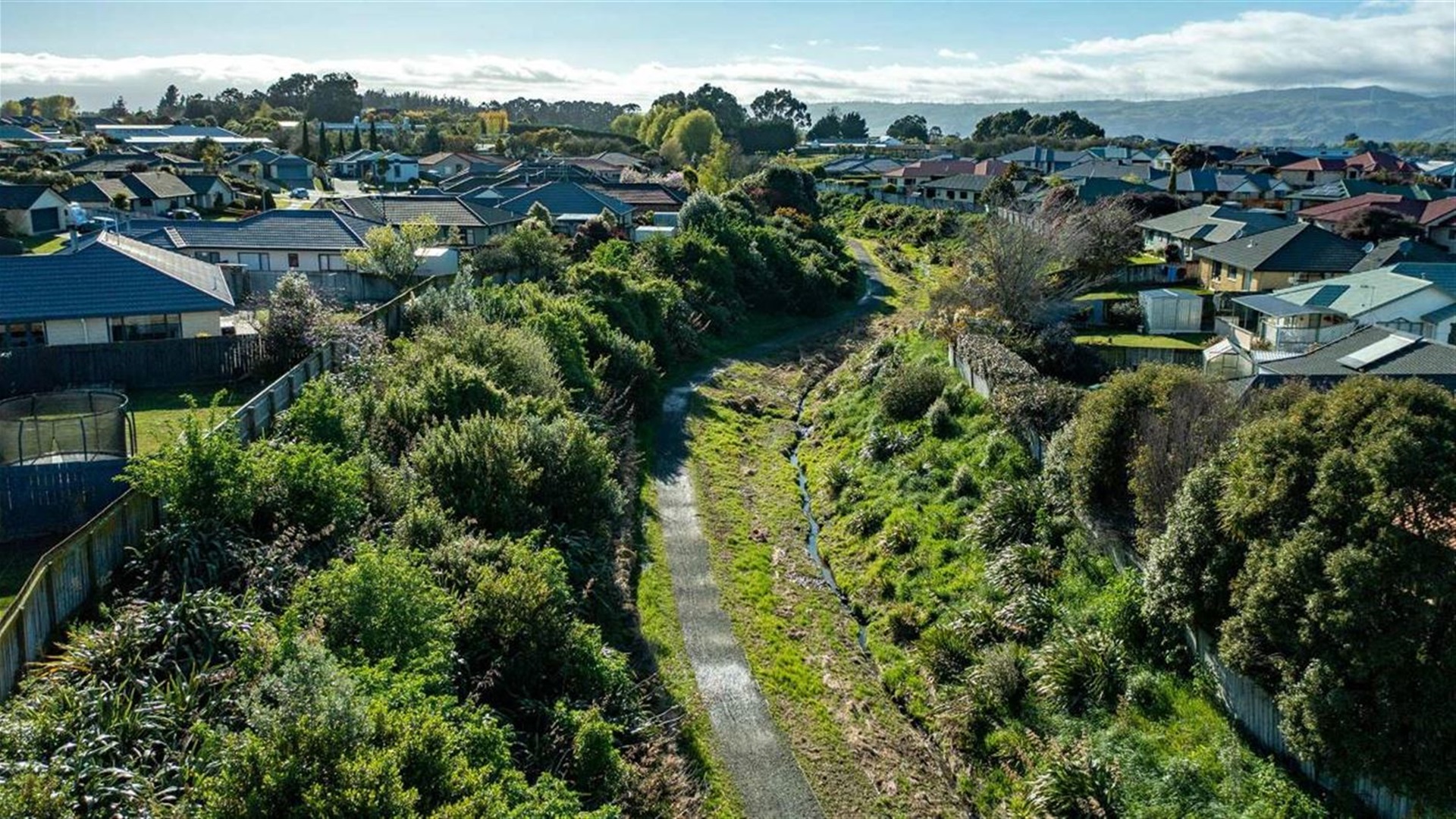 Aerial view of a gravel walkway surrounded by trees.