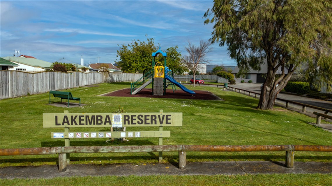 Picture shows the equipment and a bench on the playground.