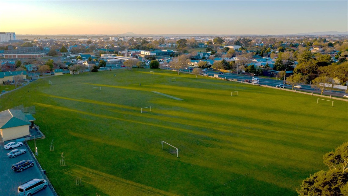 Aerial view of sportsfields surrounded by suburban homes.